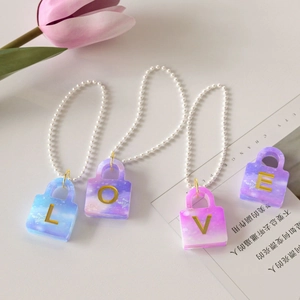 DIY resin alphabet charms in purple blue star theme with LOVE letters and heart locks