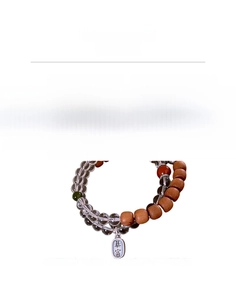 Detail view of S925 silver tag engraved with characters on crystal and wood bead bracelet