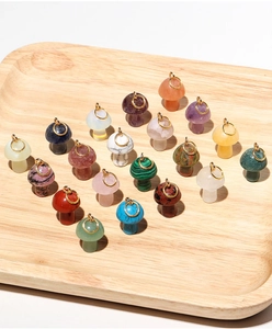 Detailed overhead view of mini mushroom pendants in various natural stones and crystals