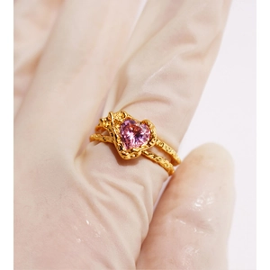 Adjustable golden open ring featuring a pink heart zircon with textured double bands