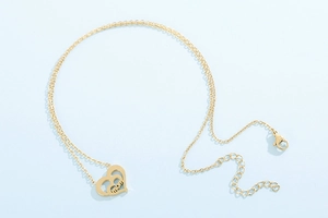 Detailed view of a gold double-heart MOM pendant necklace for Mother's Day gift