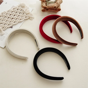 Detailed close-up of handmade velvet padded headbands in burgundy, black, brown, and grey