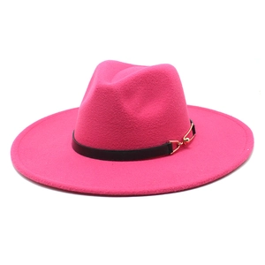 Close-up of hot pink wide-brim fedora with black leather band and gold metal buckle