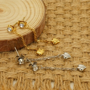 Detail of heart tassel drop earrings with sparkling rhinestones in gold and silver