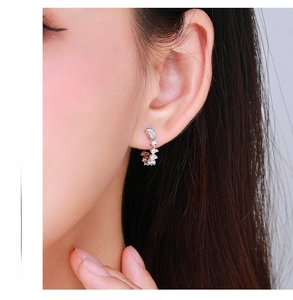 Close-up of S925 silver C-shaped stud earrings with inlaid cubic zirconia on model