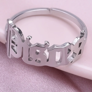 Detailed macro shot of silver Pisces zodiac ring with adjustable gothic font band