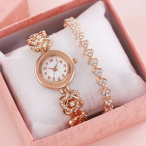 Close-up of rose gold watch and heart bracelet set with rhinestones in a gift box
