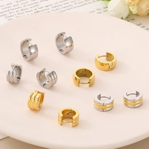 Detail of assorted triple-ribbed and smooth 18K gold-plated hoop earrings on a display tray
