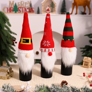 Detailed view of three knitted gnome wine bottle covers with red and green hats and plush beards