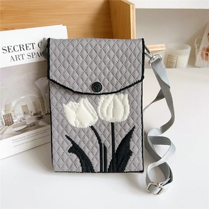 Detail of grey knitted tulip phone bag showing thick texture and metal strap hooks