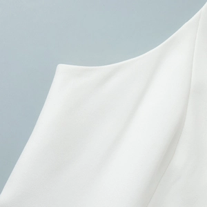 Detailed macro view of white ribbed knit fabric texture on suit vest and shorts set