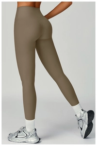 Detail view of high-waisted ribbed yoga leggings with a push-up effect and taupe knit texture