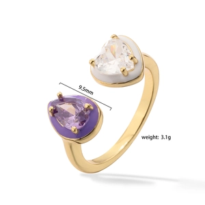 Detail view of gold open ring with colorful enamel inlay and purple water drop stone