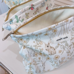 Macro shot of large capacity floral pouch showing strawberry patterns and smooth zipper