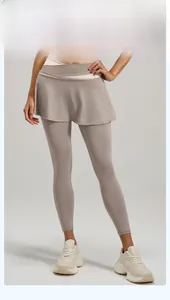 Detail of high-waisted taupe yoga skirt leggings with a crossover tummy-control waistband