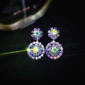Sparkling snowflake cluster earrings with yellow-green gemstone and iridescent crystals