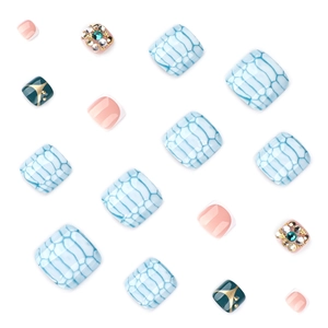 Blue snakeskin pattern press-on toenails with rhinestone accents and glitter finish