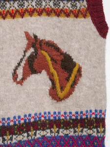 Detailed macro view of ethnic jacquard knit pattern with horse motif on beige vest