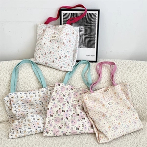 Detailed view of quilted bubble texture canvas tote bags with various cute animal prints