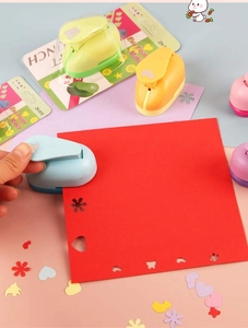 Close-up of colorful DIY paper punches with various shaped patterns and foam maker tools