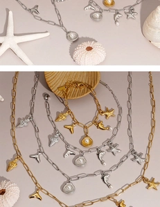 Detailed view of ocean theme starfish and shell charms on gold and silver link bracelets