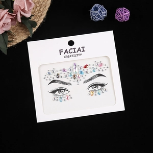 Macro shot of colorful rhinestone face stickers with teardrop gems on black background