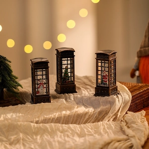 Vintage bronze Christmas lantern with Santa, snowman and tree scenes in a retro booth