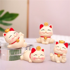 Set of four cute white fortune cat figurines with gold coins for desk or car decor