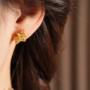 Close-up of gold-plated matte texture pony earrings in a retro New Chinese style