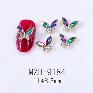 Detail view of 3D alloy butterfly nail art charms with aurora AB crystals and gold frames