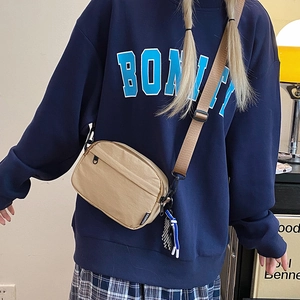 Minimalist khaki nylon crossbody bag for women with adjustable strap and fashion label