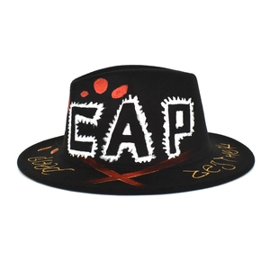 Close-up of black wool fedora with street art graffiti and bold EAP lettering detail