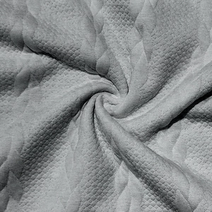 Gros plan détaillé sur la texture du tricot gris avec motif jacquard gaufré pour hommes