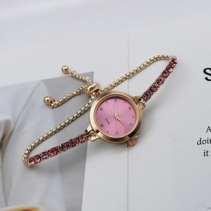 Close-up of women's quartz watch with pink rhinestone dial and adjustable slide buckle