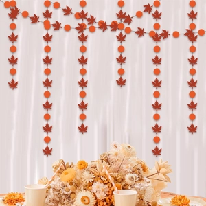 Close-up of autumn maple leaf and polka dot garlands for Thanksgiving party backdrop