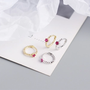 Detail of S925 sterling silver beaded hoop earrings with red zircon in gold and silver