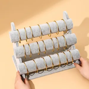 Three-tier grey velvet jewelry display stand for bracelets and watches with stable base