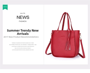 Detailed view of red lychee texture leather handbag featuring tassel and adjustable strap