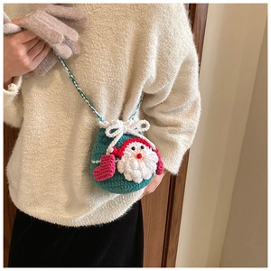 Handmade crochet Christmas Santa drawstring bag with woven strap worn by a model