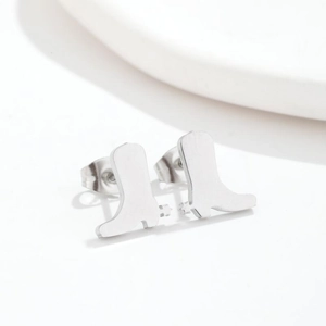 Macro shot of silver cowboy boot stud earrings in polished stainless steel