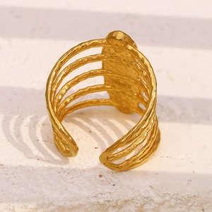 Macro shot of 18K gold plated stainless steel ring with 5-layer wave design and hammered texture