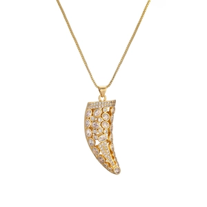 Luxurious gold horn pendant necklace with sparkling cubic zirconia on white background