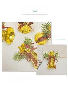 Detail of golden Christmas bell with red-green bow, rose accent, and pine needle decor