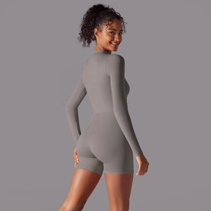 Side view of gray long sleeve athletic yoga jumpsuit showing fit and fabric detail
