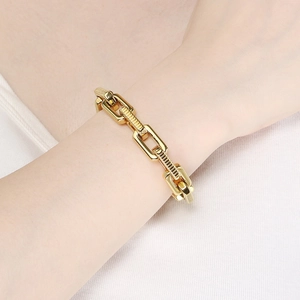 Bold golden motorcycle chain bracelet for men with textured links on white background