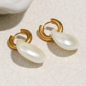 Macro view of 18K gold plated hoop earrings featuring baroque imitation pearl drops