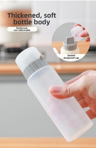 Macro view of clear plastic condiment squeeze bottle with precise ml and oz scale marks