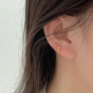Minimalist 925 sterling silver gold beaded hoop earring on female model ear