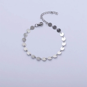Minimalist silver stainless steel bracelet featuring small round discs and lobster clasp