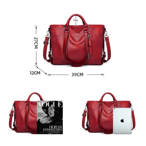 Large dark red tote bag with dimension markings and magazine for size comparison